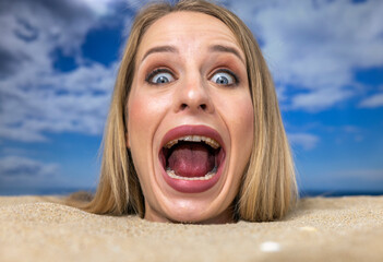 Wall Mural - Woman buried in sand on beach screaming