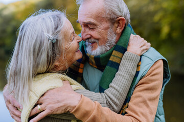 Wall Mural - Senior couple in love huging each other in autumn nature.