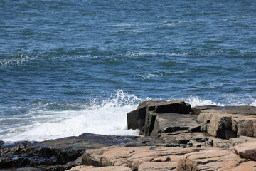 Wall Mural - Ocean crashing against a rocky shore