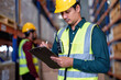 Worker in warehouse holding check list tablet pc stand portrait photo