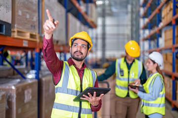 Worker in warehouse holding check list tablet pc stand portrait photo