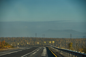 Highway through the autumn forest. Autumn forest highway