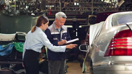 Wall Mural - Accident Inspector Inspect damage car caused by car crash on the road. Asian man Car insurance agent and woman customer examining white car by digital tablet in garage.