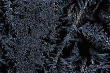 Poster - An abstract photo of a pattern of frost on a piece of glass. The macro is a black and white textured frosty crystal snowflake. The unique patterns of silver ice crystals frosted the clear glass
