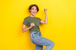 Photo of lovely adorable ecstatic girl with bob hairstyle wear khaki t-shirt scream yes win lottery isolated on yellow color background
