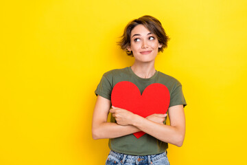 Portrait of pretty lovely lady hand hold red paper card interesting look empty space wear khaki stylish clothes isolated on yellow color background