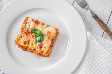 Canvas Print - Portion of lasagne on white plate