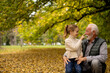 © BGStock72 - Grandfather spending time with his granddaughter in park on autumn day