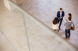 © BGStock72 - Aerial view at business people team discussing in the office hallway