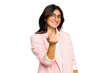 Wall Mural - Young Indian business woman wearing a pink suit isolated pointing with finger at you as if inviting come closer.