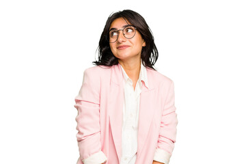 Wall Mural - Young Indian business woman wearing a pink suit isolated dreaming of achieving goals and purposes