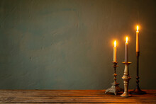 Burning Candles In Vintage Candlesticks On Dark Background