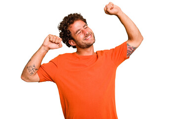 Wall Mural - Young caucasian curly hair man isolated Young caucasian man with curly hair isolated celebrating a special day, jumps and raise arms with energy.