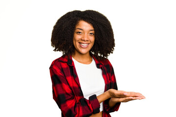 Wall Mural - Young African American woman isolated holding a copy space on a palm.