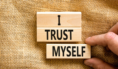 I trust myself symbol. Concept words I trust myself on wooden blocks. Businessman hand. Beautiful canvas table canvas background. Business, psychological and I trust myself concept. Copy space.
