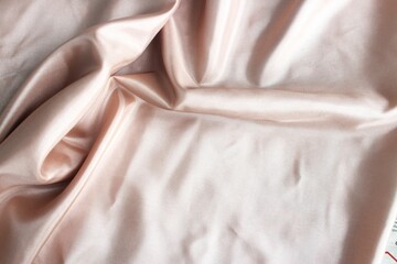 Wall Mural - Beautiful soft beige fabric, folded in soft folds. Silk, satin or satin ribbon.