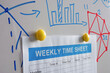 Weekly time sheet pinned to the whiteboard in the office.