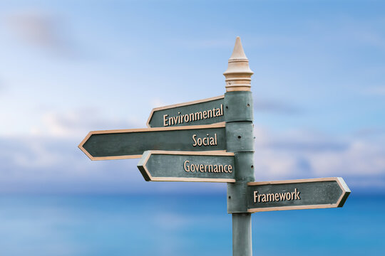Wall Mural - environmental social governance framework four word quote written on fancy steel signpost outdoors by the sea. Soft Blue ocean bokeh background.
