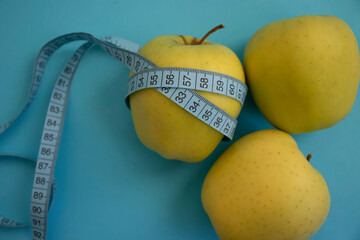 Wall Mural - Apple measuring tape on colored background