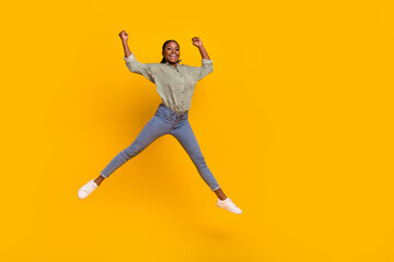 Sticker - Full length photo of excited astonished lady jumping raise fists luck isolated on yellow color background