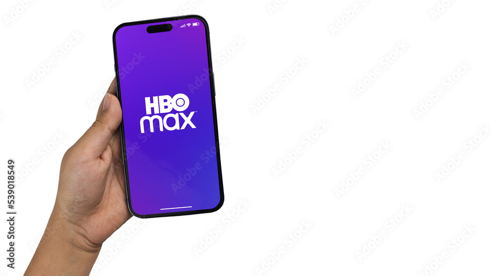 Boy holding a smartphone iPhone 14 Pro with Hbo Max streaming app app ...