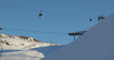 Wall Mural - Ski lift cabin in snowy mountain landscape