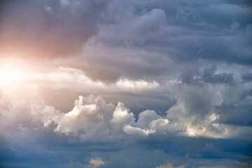 Wall Mural - Breaking sunlight through gap of storm clouds.