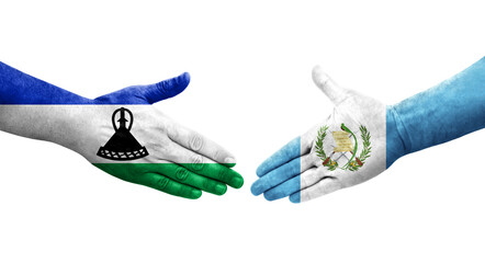 Handshake between Guatemala and Lesotho flags painted on hands, isolated transparent image.