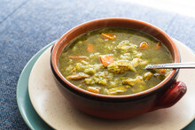 Peruvian Food Soup With Cilantro, Carrots And Chicken Called Aguadito. 