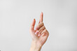 © RaspberryStudio - Woman's hand with one finger up on white background