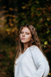 © Maria - Young women in white sweater standing and looking