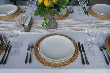 Wall Mural - Festive table at the wedding party decorated with lemon arrangements