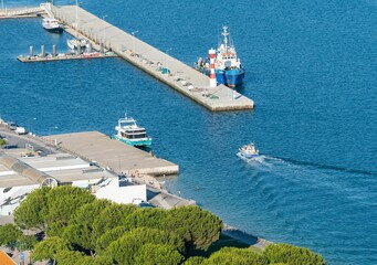 Poster - Aerial view of fishing boats by the port in Setubal, Portugal with bright blue water on a sunny day