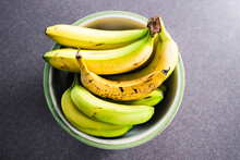Fruit Bowl With Bunches Of Bananas With Only One Being Ripe