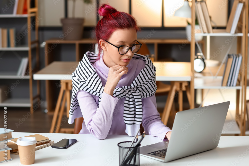 Young female student preparing for exam at home