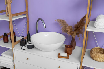 Poster - Modern sink and different bath accessories near color wall in bathroom