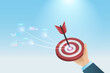© Kate3155 - Success business marketing target. Businessman hand hold dartboard hit on red target with growth graph and business report. Achievement, goal and competitive in business marketing and strategy.