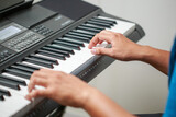 Fototapeta Zwierzęta - Close-up of male hands playing keyboard