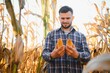 © Serhii - A man inspects a corn field and looks for pests. Successful farmer and agro business.