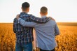 © Serhii - Two young men hugging against the backdrop of the sunset, looking forward to the horizon.