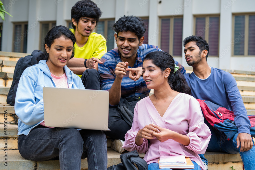 image of a student happily checking results on a laptop