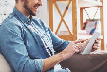 Canvas Print - Young man with gadget at home