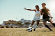 © Allistair F/peopleimages.com - Sport, friends and soccer with man and woman playing on a soccer field, competitive training for sports goal. Fitness, couple and energy with interracial guy and lady having fun with outdoor football