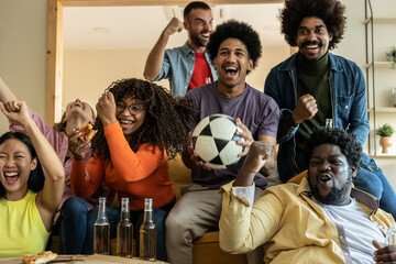 Group of friends having fun at home,watching game and enjoying together.