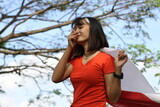 Fototapeta  - Asian women are happy carrying the Indonesian flag
