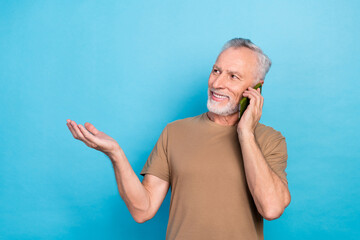 Sticker - Photo of positive senior man arm demonstrate present empty space look promo ad enjoy speed connection isolated on blue color background