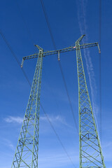 Wall Mural - Pylons for high voltage transmission line. View from underside to masts with glass disk insulators, sky and clouds.