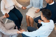 © Anela R/peopleimages.com - Support, holding hands and business people in team building, therapy group or mental health work counseling service. Corporate people in community circle for commitment, partner trust or cooperation