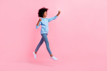 Wall Mural - Full body profile photo of small girl jump take selfie demonstrate thumb up isolated on pink color background