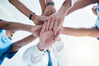 © Anela R/peopleimages.com - Below, group and hands stack for medical, staff and teamwork in hospital for motivation. Team, doctor and nurse with hand for collaboration, healthcare and help in community at job together in clinic